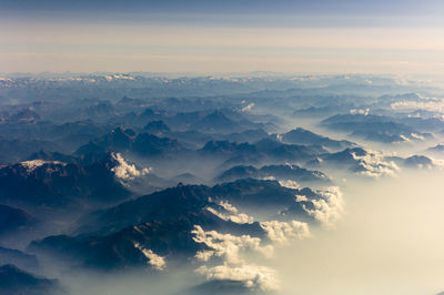 Aerial view of mountains against sky during sunset