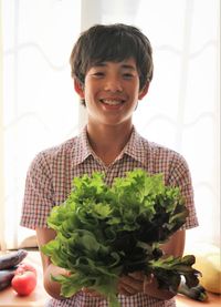 Portrait of smiling young woman holding food