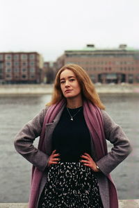 Portrait of beautiful young woman standing outdoors