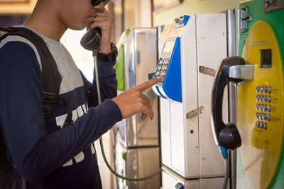 Man using pay phone