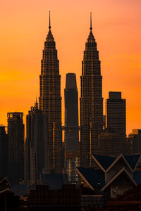 Modern buildings against sky during sunset