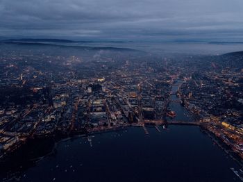 High angle view of river and buildings against sky