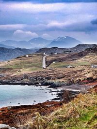 Scenic view of mountains against cloudy sky