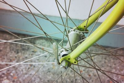 Close-up of bicycle on metal fence by sea