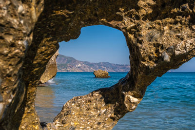 Beautiful view of the mediterranean sea through rock formations at nerja beach.