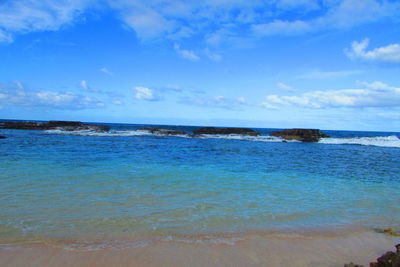 Scenic view of sea against blue sky