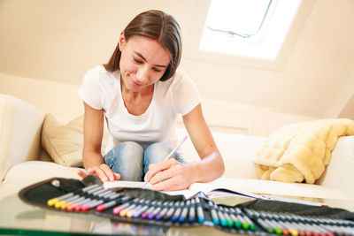 Woman sitting on sofa at home