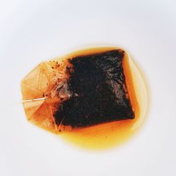 Close-up of bread over white background