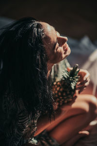 Side view of a woman holding food