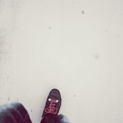 Low section of person standing on tiled floor
