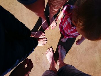 Low section of people standing at beach