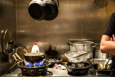 Cropped image of man standing by kitchen counter