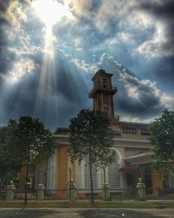 Low angle view of church against cloudy sky