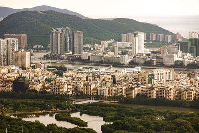 High angle view of river and buildings in city