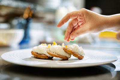 Midsection of person with ice cream in plate