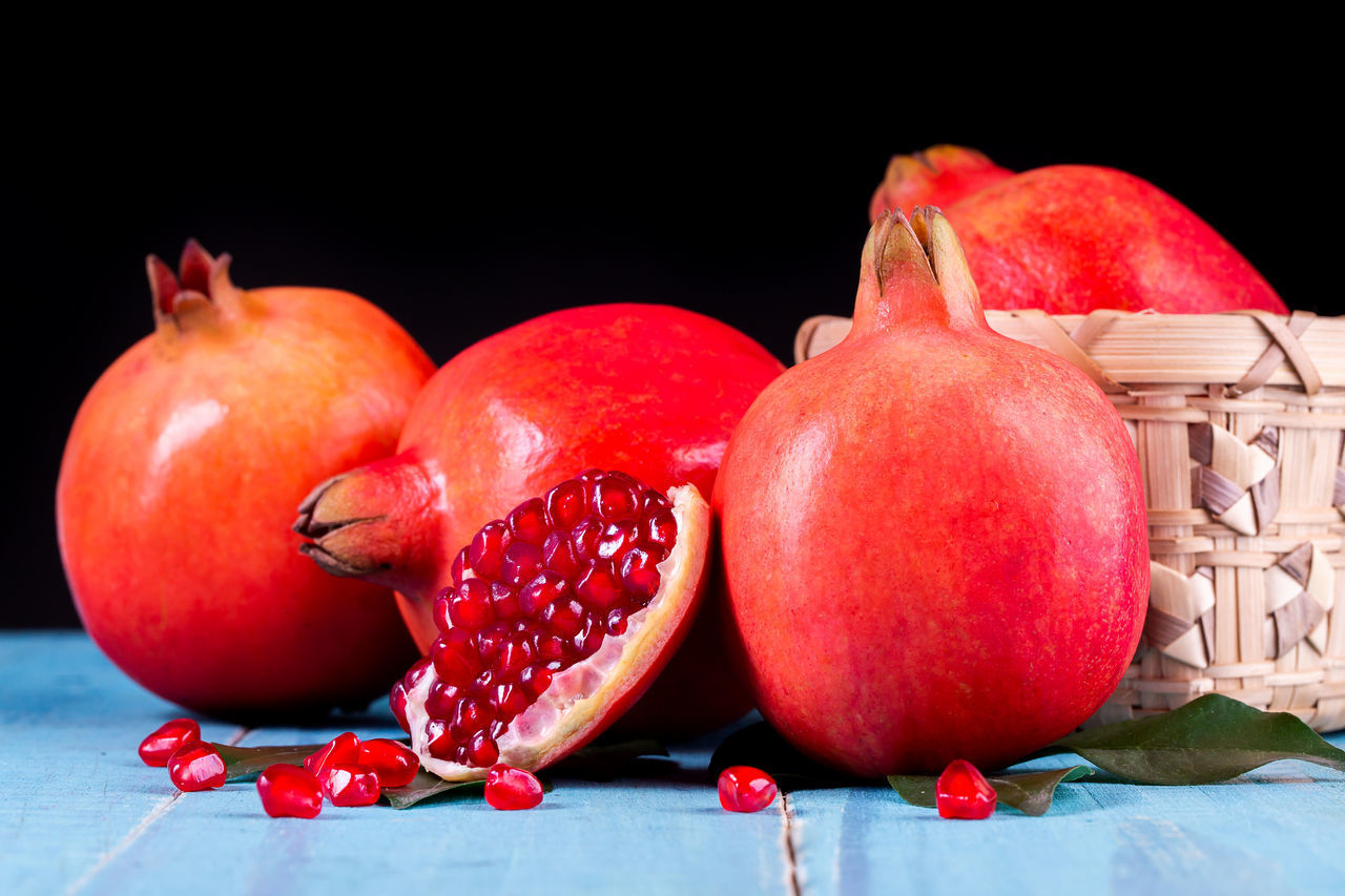 CLOSE-UP OF RED FRUITS ON TABLE