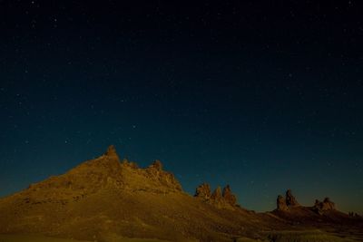 Scenic view of mountains against clear sky at night