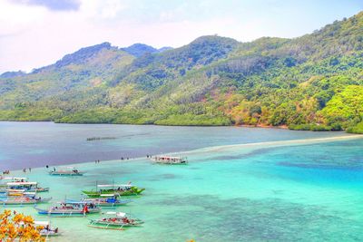 High angle view of sea and mountains against sky