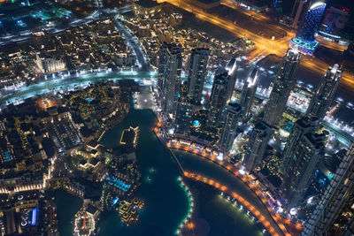 High angle view of city lit up at night