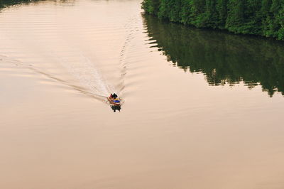 High angle view of people in rowboat at lake