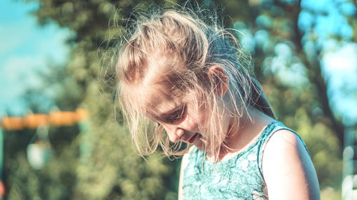 Close-up of girl against trees