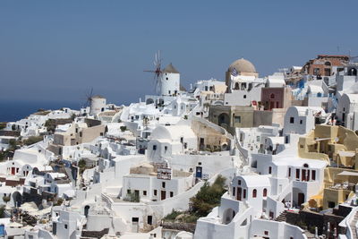 Buildings in town against clear sky