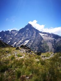 Scenic view of mountains against blue sky