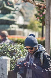 Young man holding camera