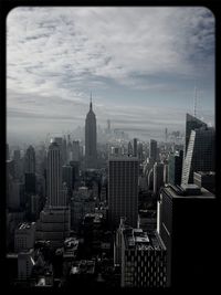 City skyline against cloudy sky