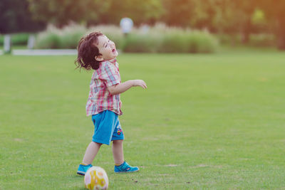 Full length of cute girl on field