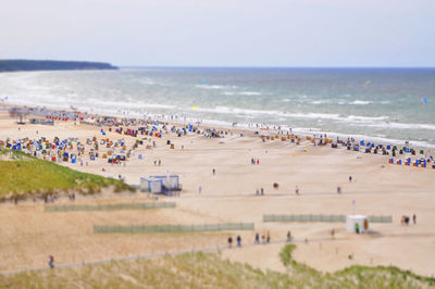 People on beach against sky