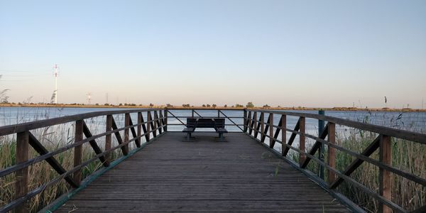 Pier over sea against clear sky