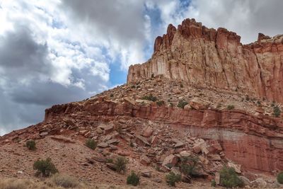 View of rock formations against cloudy sky