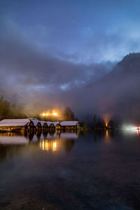 Scenic view of lake against sky at night