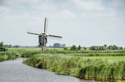 Dutch polder canal with windmill