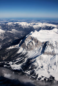 Aerial view of snowcapped mountains against sky