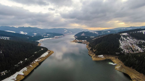 High angle view of river amidst mountains against sky