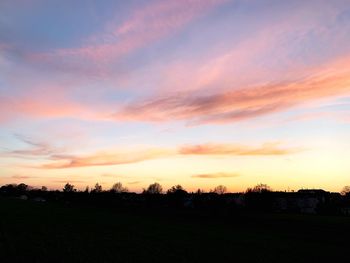 Silhouette landscape against sky during sunset
