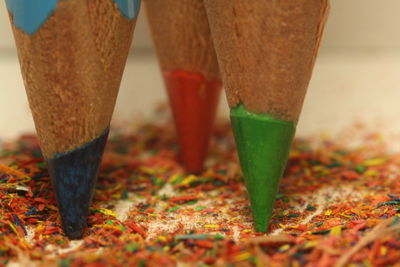 Close-up of colored pencils on shavings