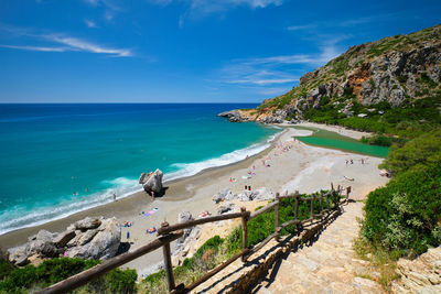 Scenic view of beach against blue sky