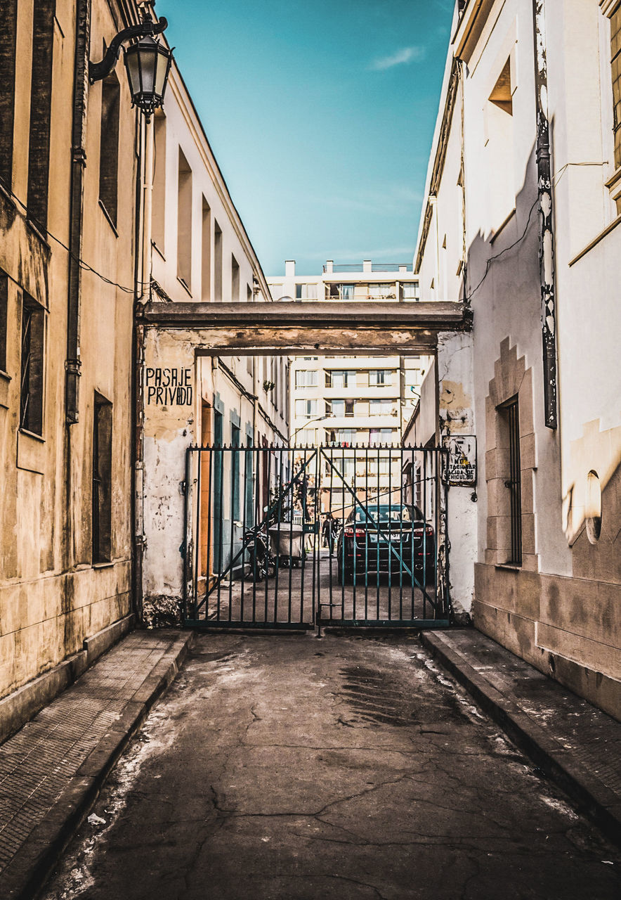 architecture, street, urban area, road, built structure, building exterior, alley, city, sky, building, no people, neighbourhood, nature, infrastructure, town, day, outdoors, residential district, old, history, travel destinations, sunlight, the past, transportation