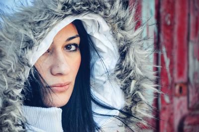 Close-up portrait of beautiful woman wearing fur hood