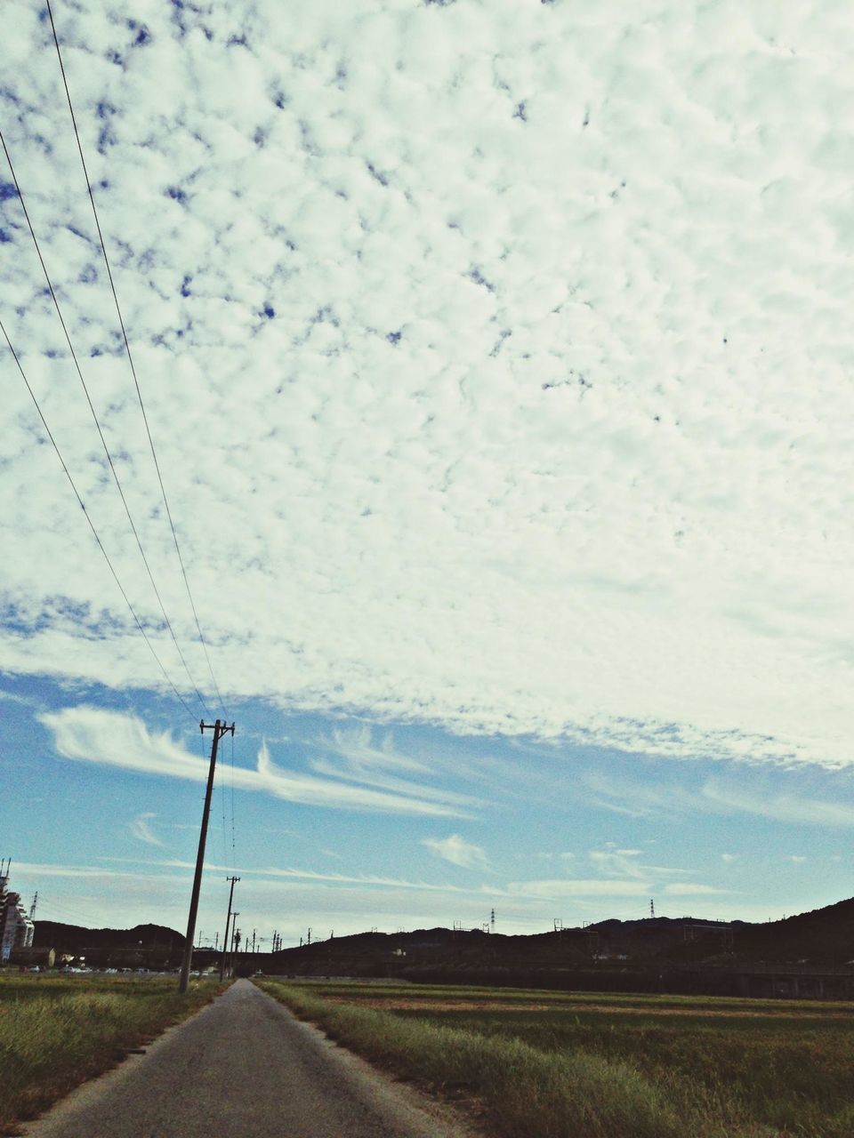 sky, the way forward, electricity pylon, power line, road, transportation, landscape, cloud - sky, field, diminishing perspective, electricity, vanishing point, cloud, country road, cloudy, power supply, fuel and power generation, connection, tranquil scene, tranquility