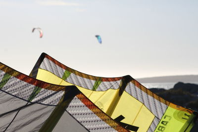 Low angle view of flags against clear sky