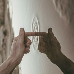 Tilt image of finger touching water