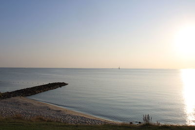 Scenic view of sea against clear sky during sunset