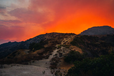 Scenic view of mountains against orange sky