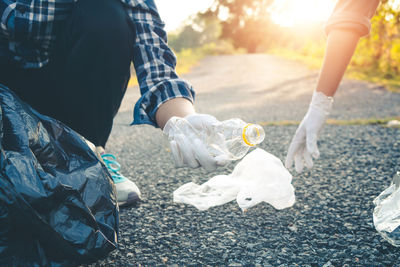 Low section of volunteers cleaning garbage from road