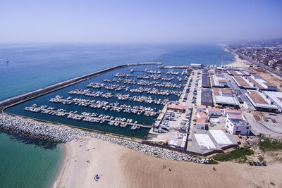 Aerial view of harbor against clear blue sky