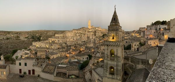 Panoramic view of buildings in town against sky